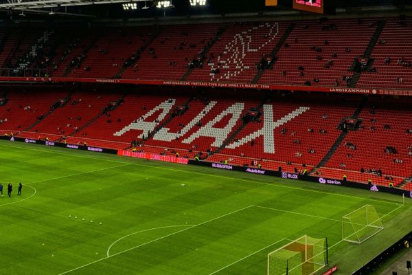 Stand in Johan Cruyff Arena featuring the word "Ajax" alongside the club badge depicting the mythical hero Ajax.