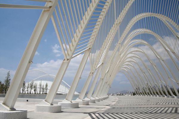 View of Athens Olympic Stadium in the distance, a modern architectural marvel and home to AEK Athens and Panathinaikos.