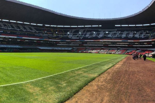 Pitchside view at Estadio Azteca, showcasing the field and stands.