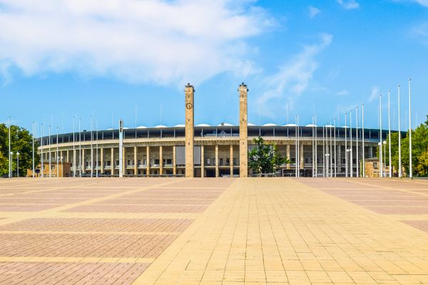 Exterior view of Olympiastadion Berlin, featuring its iconic arch and historical architecture.