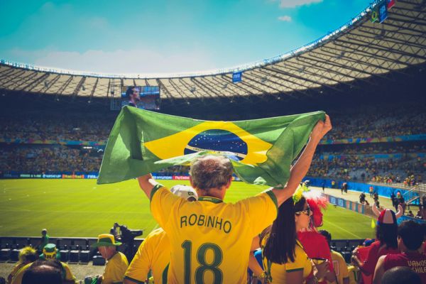 Brazil fan at the Maracanã Stadium wearing a modern yellow shirt with green trim.