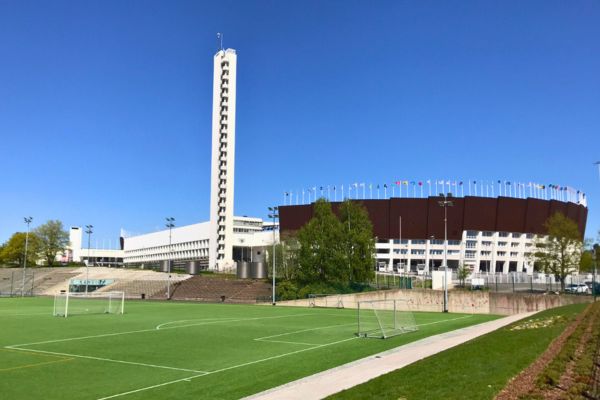 Exterior view of Helsinki Olympic Stadium, showcasing its iconic tower and modern architecture.