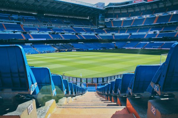 View of seats and steps looking down at the playing surface in the empty Santiago Bernabéu Stadium