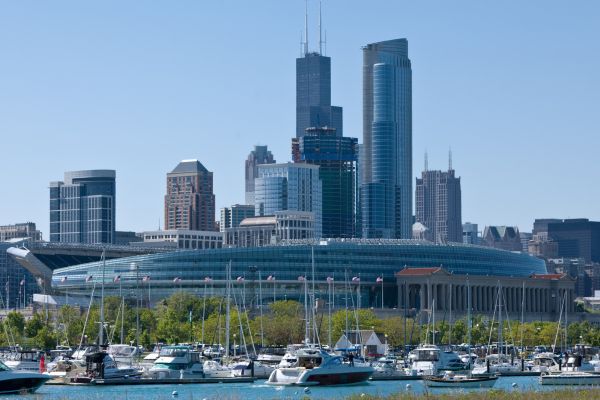 Soldier Field stadium with Chicago skyline in the distance and Lake Michigan in the foreground.