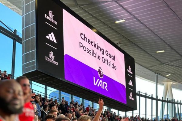 Big screen at Emirates Stadium displaying a VAR check during a football match, reflecting modern technology in the game.