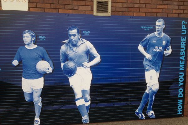 Dixie Dean (centre) with fellow Everton legends Alan Ball and Duncan Ferguson posing together on a wall outside Goodison Park Stadium.