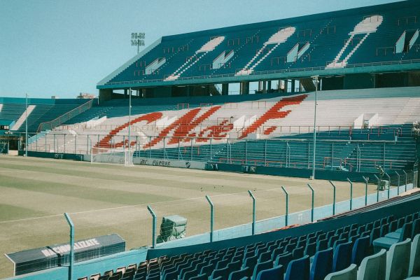 Empty stands inside Club Nacional de Football stadium with white and blue seating.