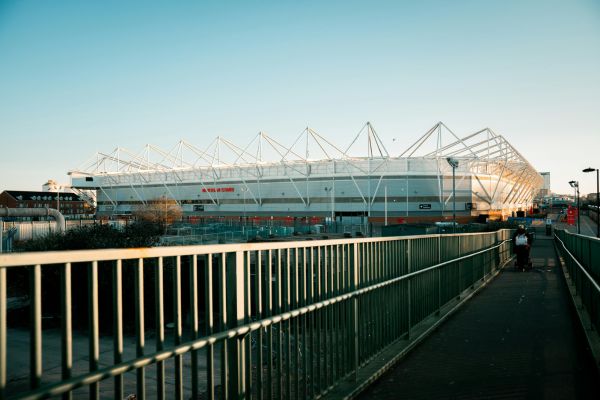 Exterior view of St Mary’s Stadium, home of Southampton FC, on a matchday with fans gathered outside.