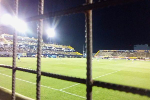 View from the terrace of CA Atlanta stadium at night under floodlights, behind the fence.