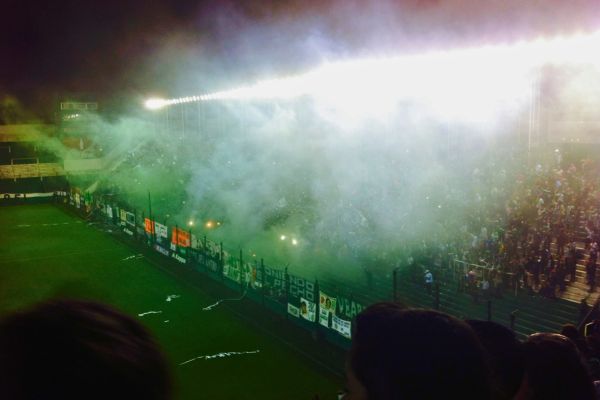 Banfield fans create a sea of green smoke in the stands with flares during a match at Estadio Florencio Sola.