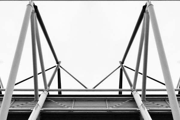 Black and white image showcasing the modern architectural frame of Pride Park Stadium, home of Derby County FC.