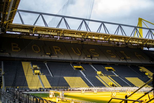 Empty stands at Signal Iduna Park in Dortmund, Germany, showcasing the modern design and seating layout of the stadium.