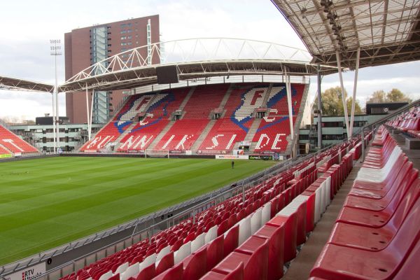 Stand at Stadion Galgenwaard, home of FC Utrecht, with red seating and fan banners.