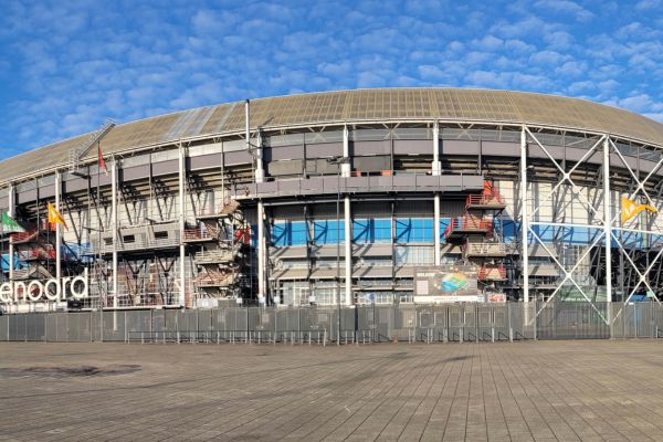 Exterior view of Feyenoord Stadium, also known as De Kuip, in Rotterdam, Netherlands, highlighting its classic bowl design and entrance.