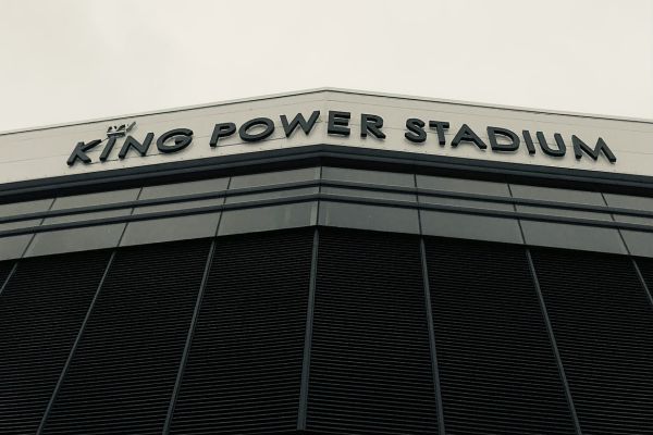 Black and white image of the King Power Stadium sign displayed outside the stadium entrance.