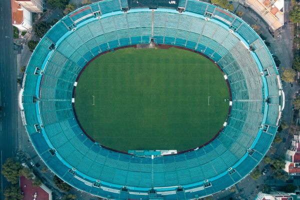 Aerial view of Estadio Ciudad de los Deportes, showcasing its modern architecture and empty stands.