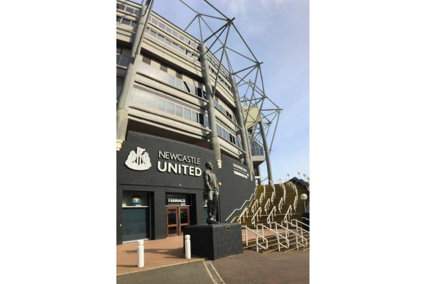 Outside view of St. James' Park with the statue of Sir Bobby Robson in front of the stadium.