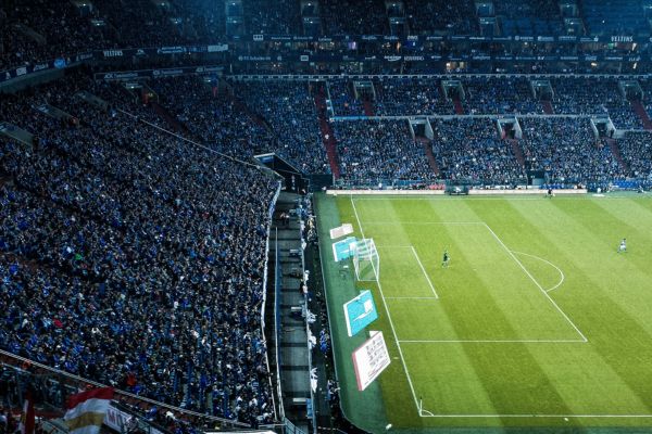 A vibrant view of the stands at Schalke 04 Stadium during a night match