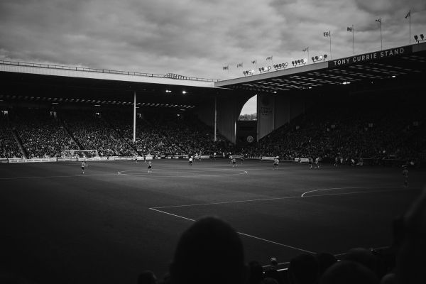 View of the interior of Bramall Lane Stadium during a matchday, showcasing the pitch, stands filled with passionate Sheffield United fans, and the vibrant atmosphere.