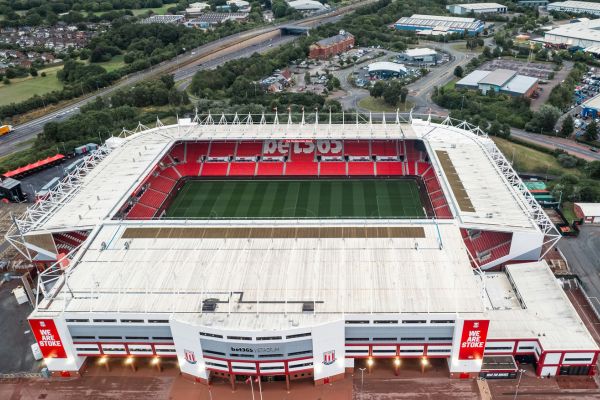 Aerial view of the Bet 365 Stadium in Stoke-on-Trent, showcasing its structure and surroundings, with the seating area empty.