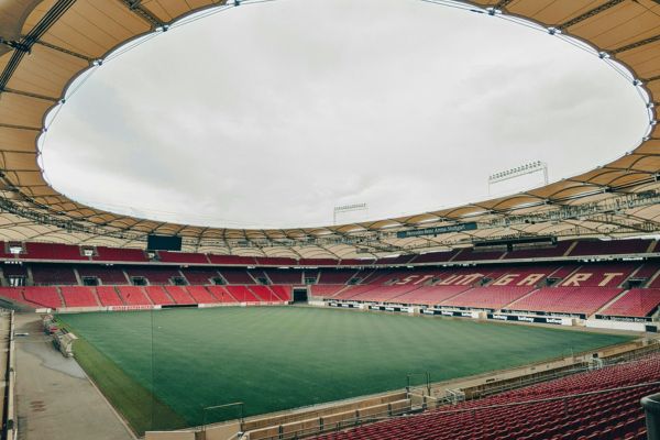 Inside view of the MHP Arena with empty stands, showcasing the football pitch and modern seating.