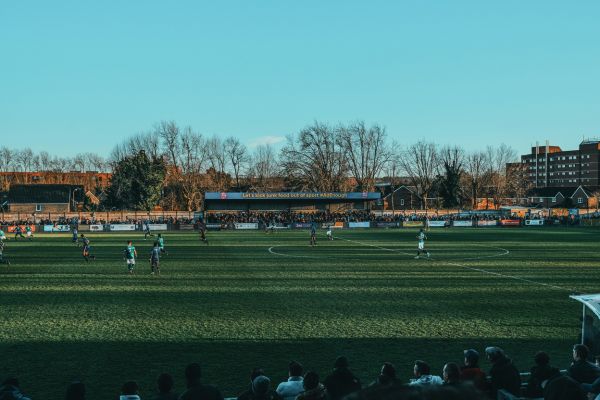 Fans enjoying a vibrant matchday atmosphere at Champion Hill Stadium, home of Dulwich Hamlet FC.