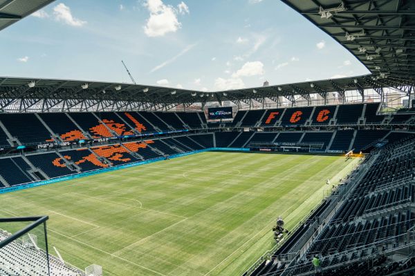 An interior view of the empty TQL Stadium, showcasing its modern design and expansive seating.