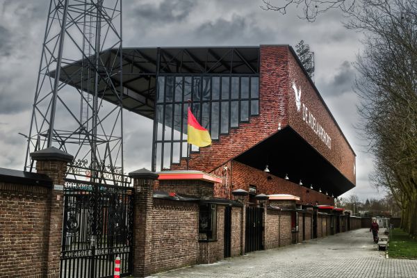 Exterior view of De Adelaarshorst, home of Go Ahead Eagles, with its iconic entrance and team colors.