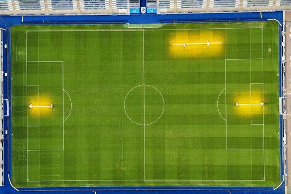 A stunning aerial view of the John Smith’s Stadium, showcasing the vibrant green pitch and surrounding stands.