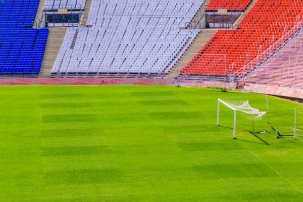 Colorful seats in blue, red, and white at Estadio Malvinas Argentinas in Mendoza, Argentina.