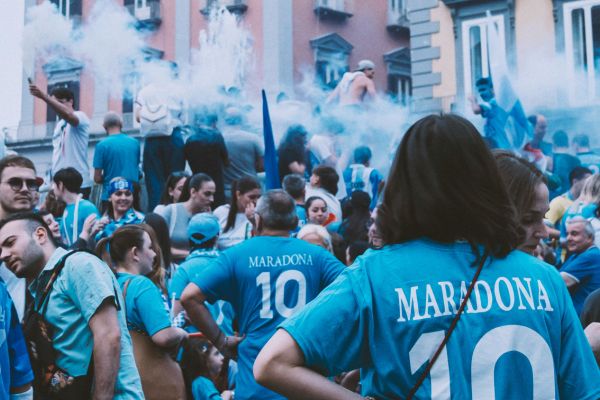 SSC Napoli fans wearing Maradona jerseys, celebrating the legendary footballer's legacy.