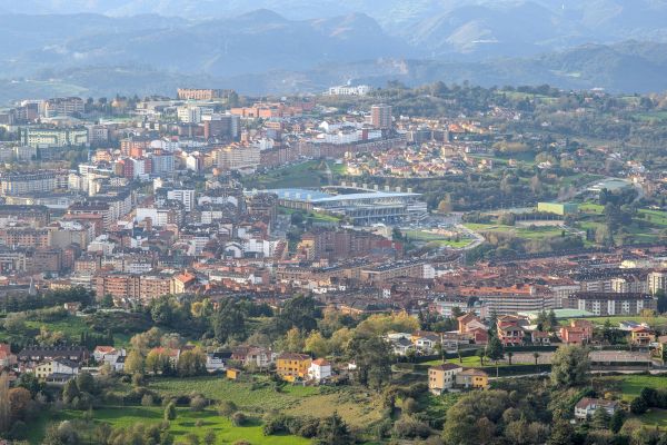 A distant view of Carlos Tartiere Stadium, home of Real Oviedo, showcasing its unique architecture and surrounding area.