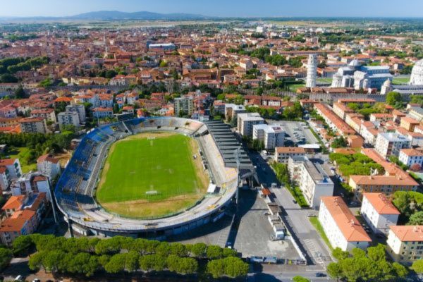 Aerial view of Arena Garibaldi – Stadio Romeo Anconetani in Pisa, showcasing the stadium's structure and its proximity to the Leaning Tower of Pisa.