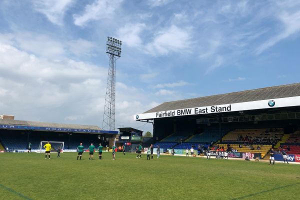 An inside view of Roots Hall Stadium, showcasing the stands and pitch on a matchday.