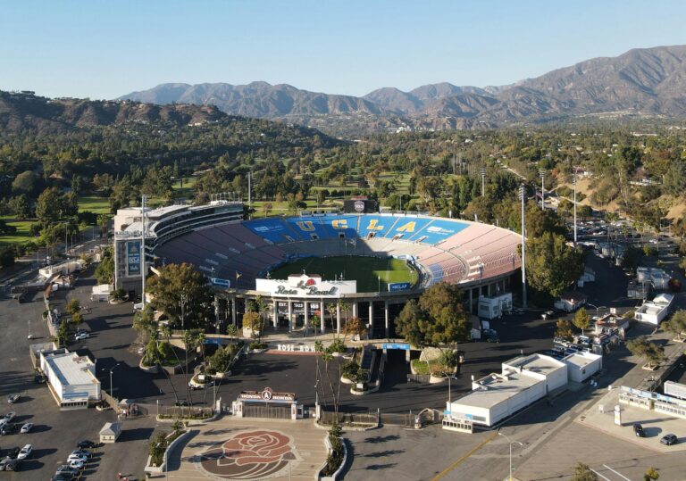 A breathtaking aerial view of the Rose Bowl Stadium in Pasadena, California, showcasing its iconic oval design and scenic surroundings.