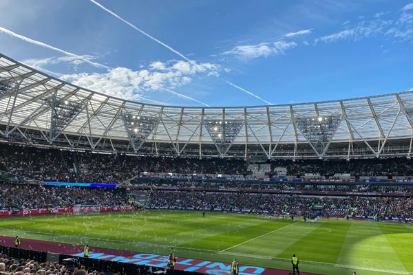 Matchday at West Ham’s London Stadium, with bubbles floating through the air as fans cheer on their team. The atmosphere is lively and filled with excitement during a West Ham United FC match.