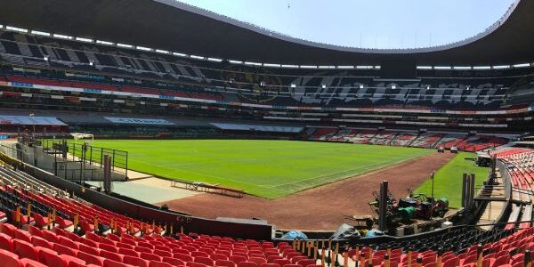 View of the Estadio Azteca pitch near Nachito’s statue, highlighting the iconic football field.