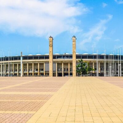 Exterior view of Olympiastadion Berlin, featuring its iconic arch and historical architecture.