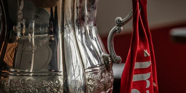Image of the FA Cup with red ribbon