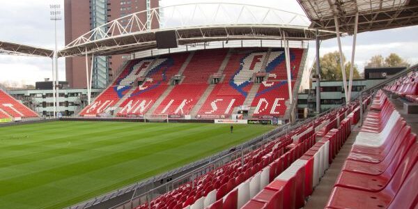 Stand at Stadion Galgenwaard, home of FC Utrecht, with red seating and fan banners.