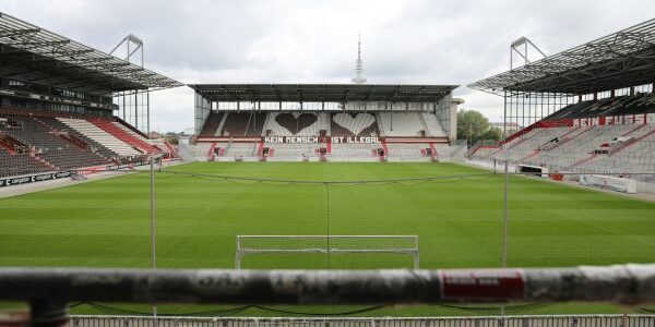 Inside view of an empty Millerntor Stadium in Hamburg, showcasing its seating, pitch, and unique atmosphere.